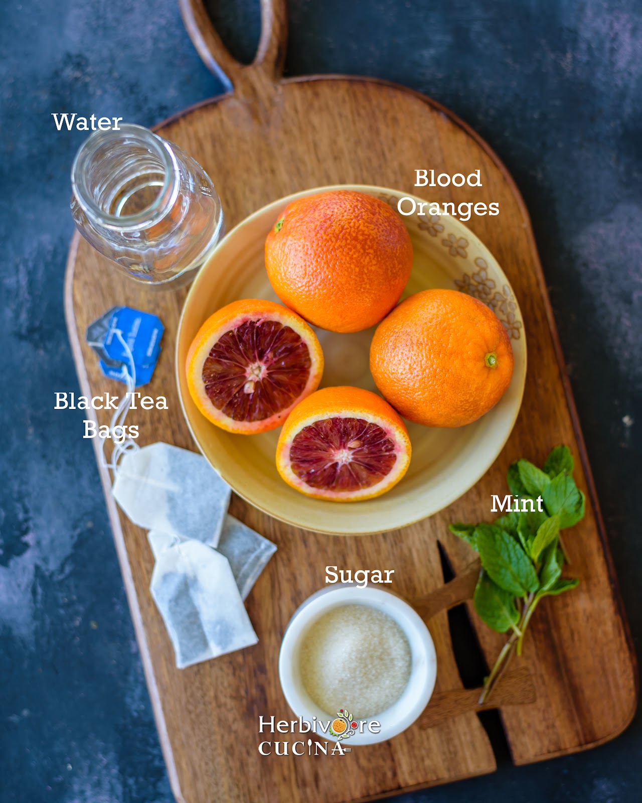 Ingredients for blood orange iced tea; blood oranges, black tea, mint, sugar and water. 