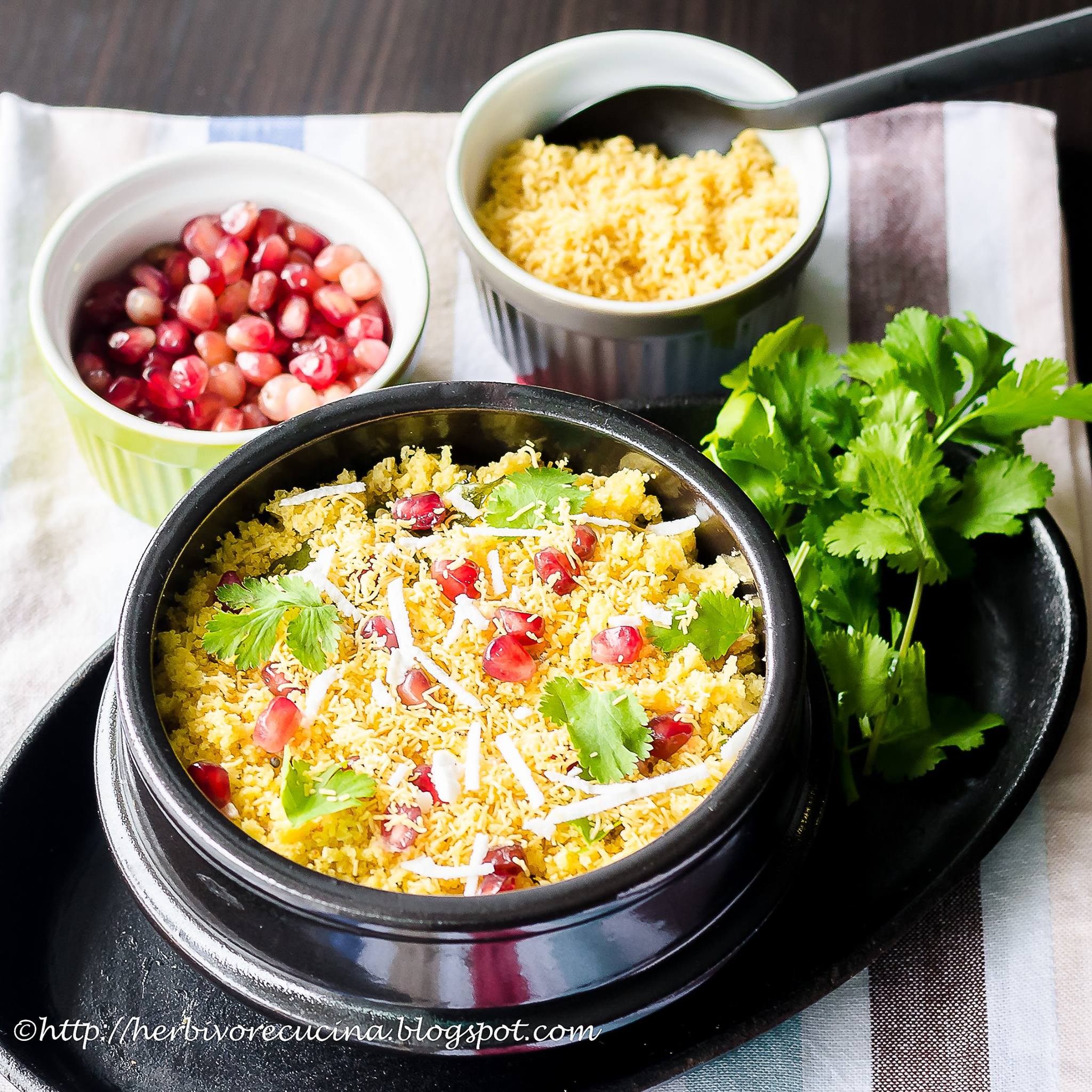 Side view of sev khamani in a black bowl with the toppings on the side.