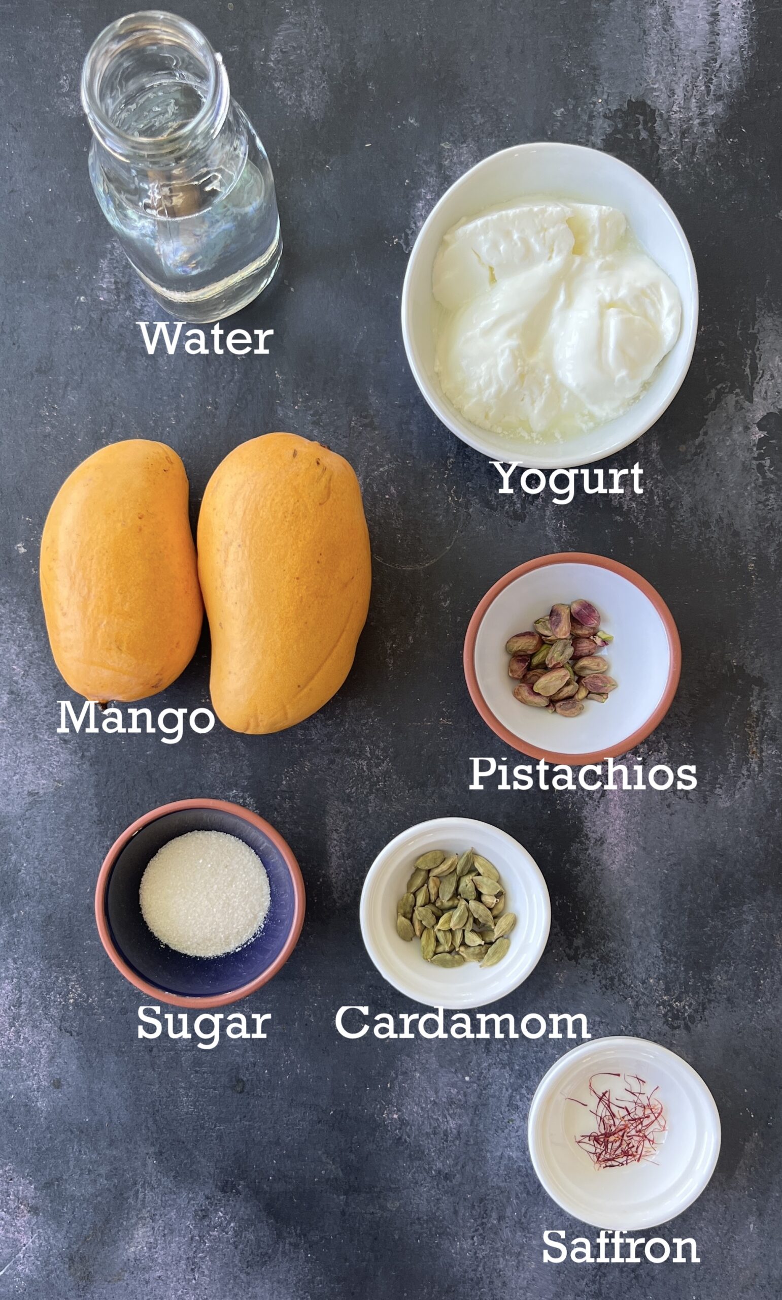 Ingredients to make Mango Lassi: yogurt, mango, sugar, water and nuts.