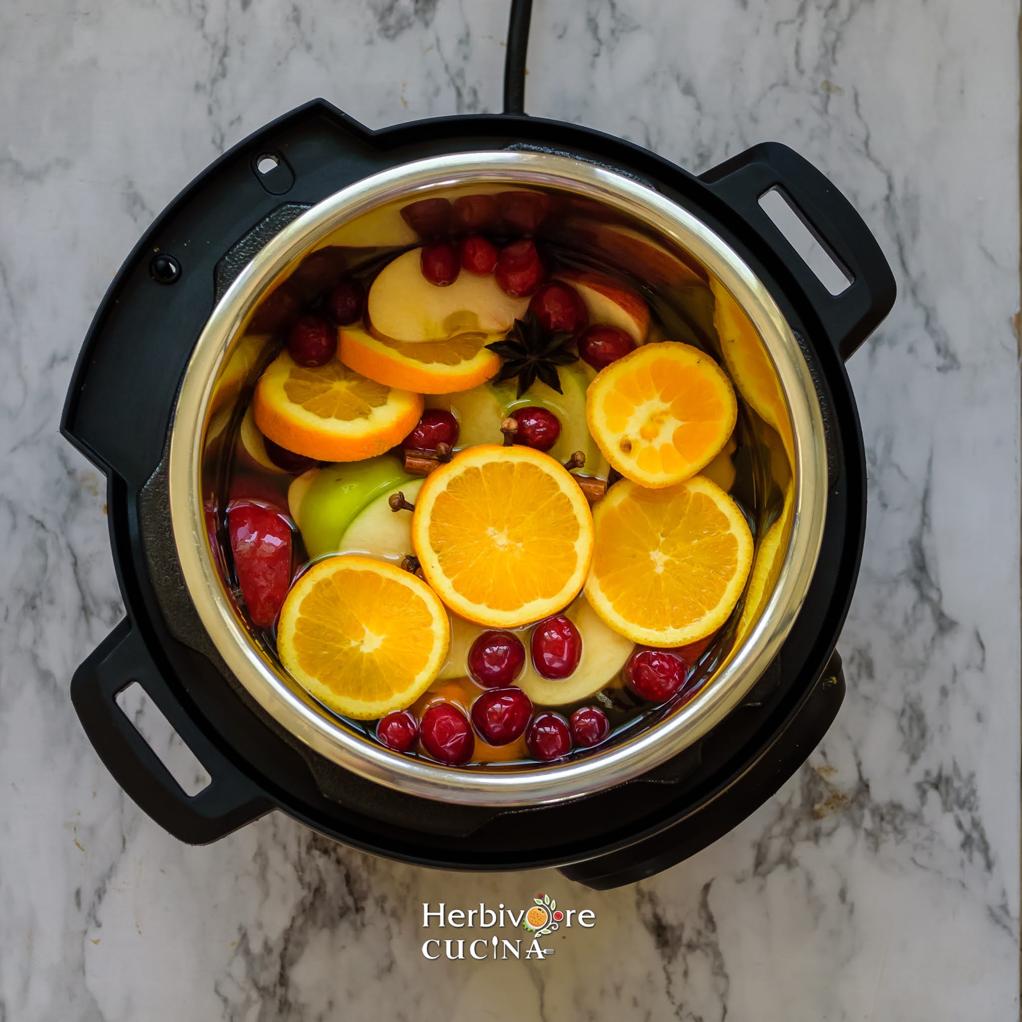 Instant Pot with Apple Cider ingredients on a white surface. 