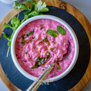 Beetroot Raita in a bowl with tadka on top