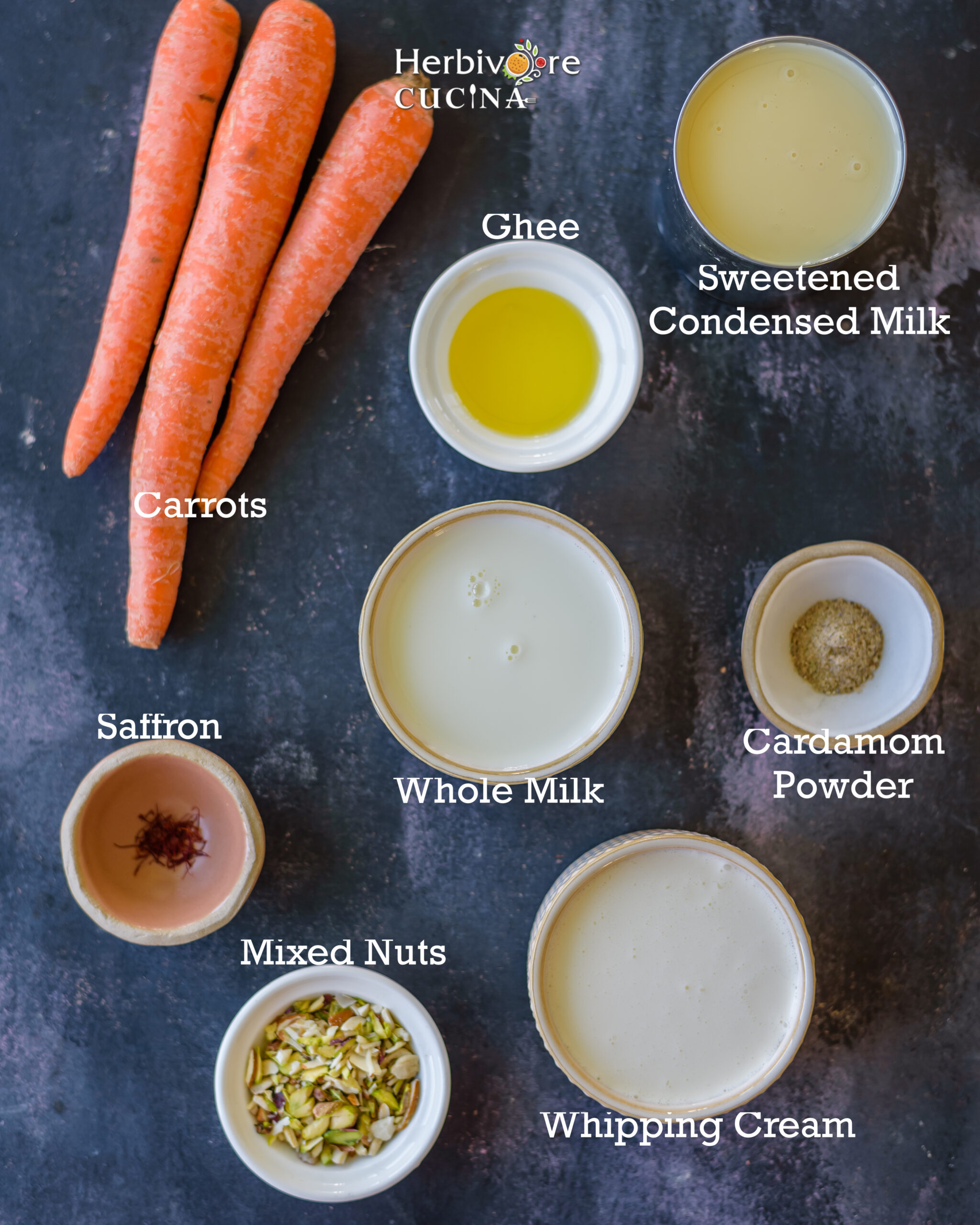 ingredients to make carrot halwa ice cream; carrots, milk, cream and some add-ins on a black backdrop. 