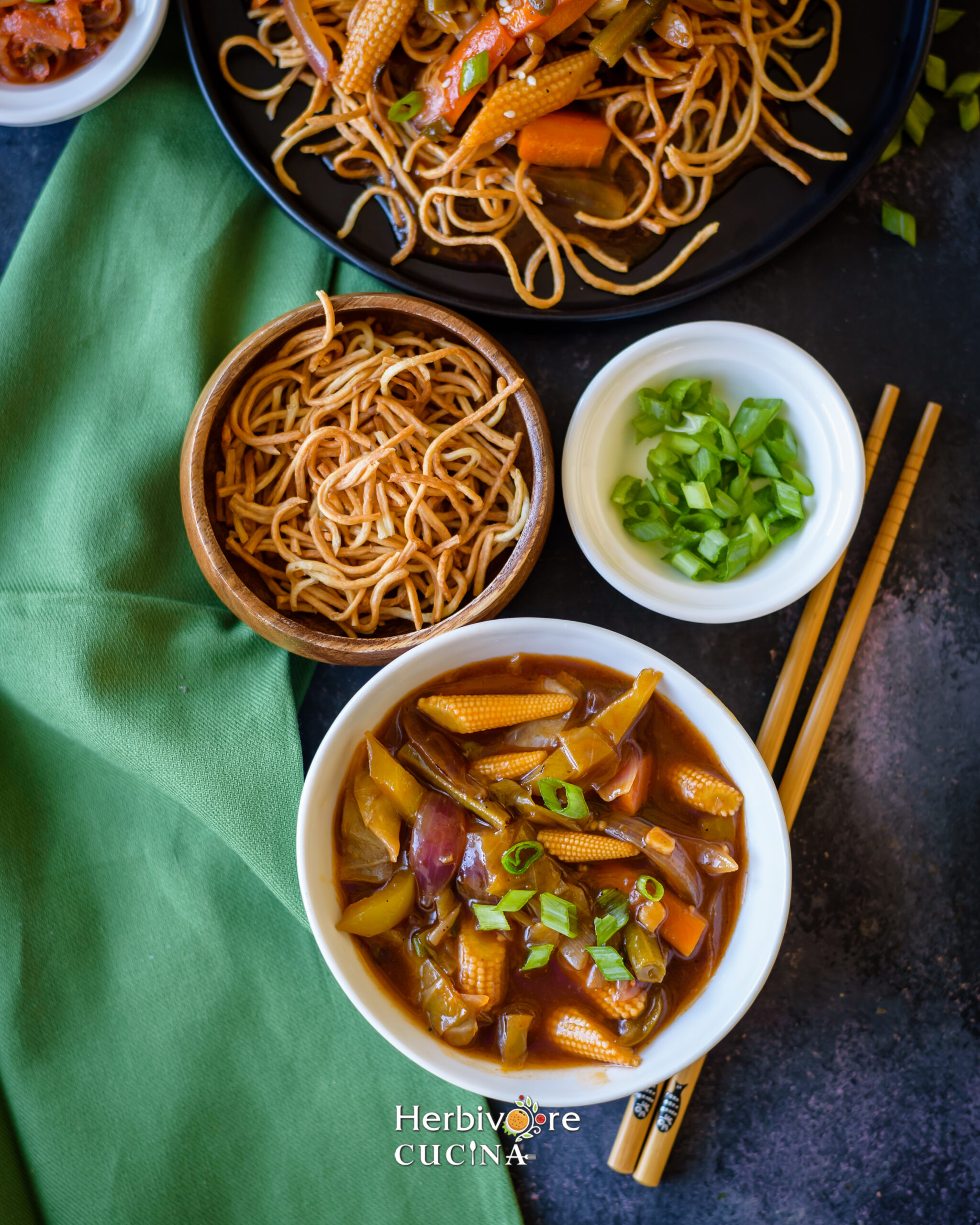 Fried Noodles and mixed vegetables in two small bowls on a black background. 