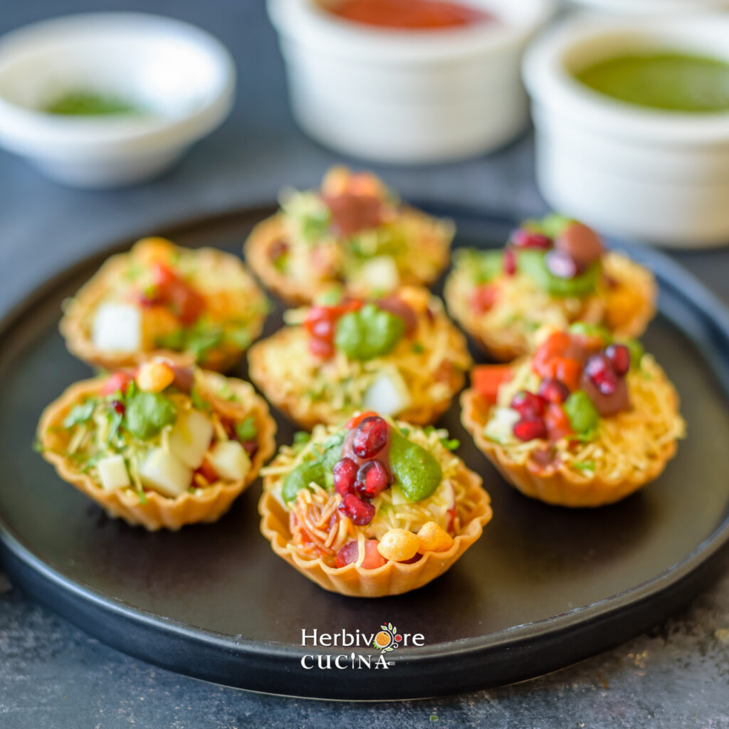 side view of plate full of chaat baskets