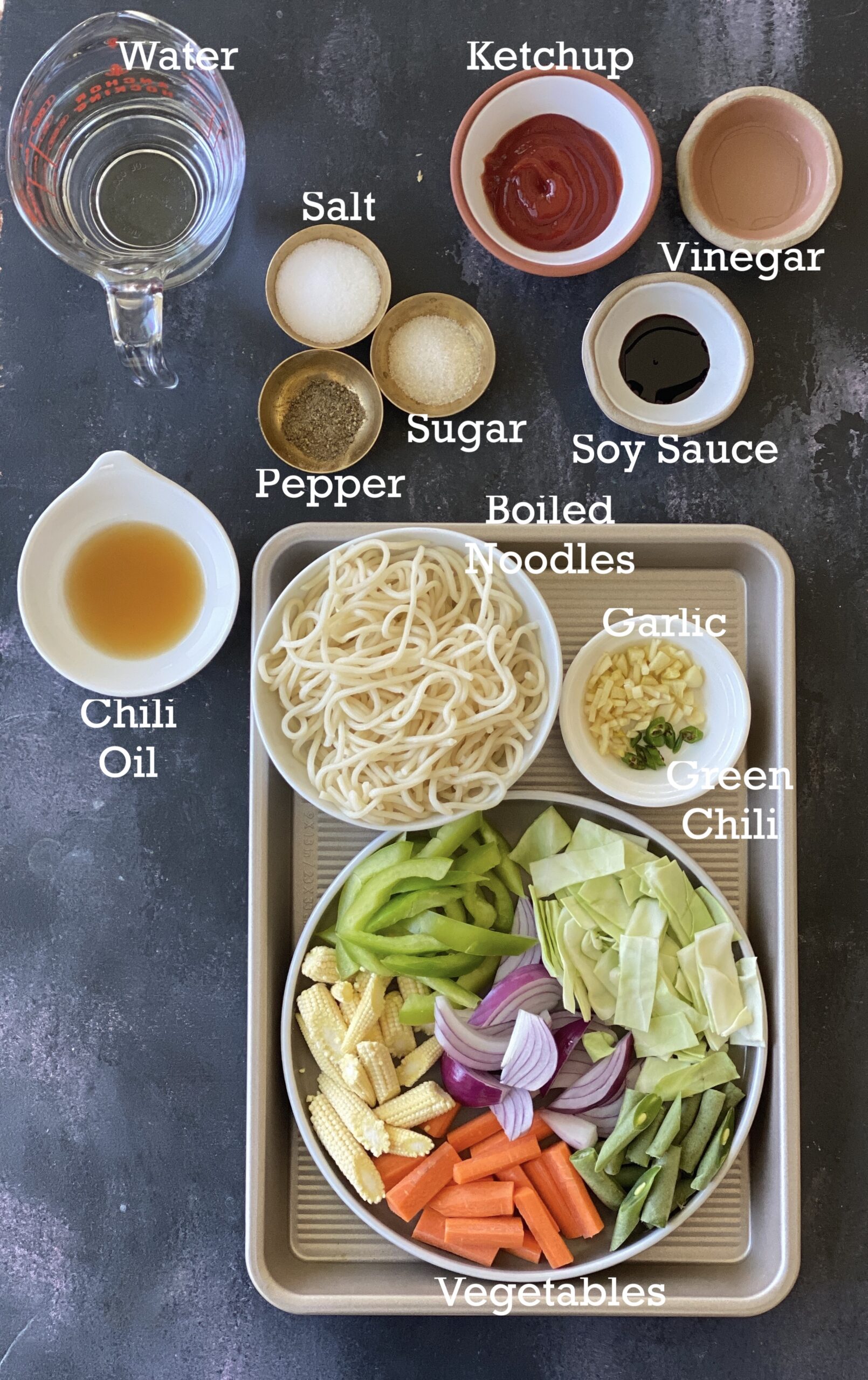 Ingredients for Asian style fried noodle recipe arranged in small bowls. 