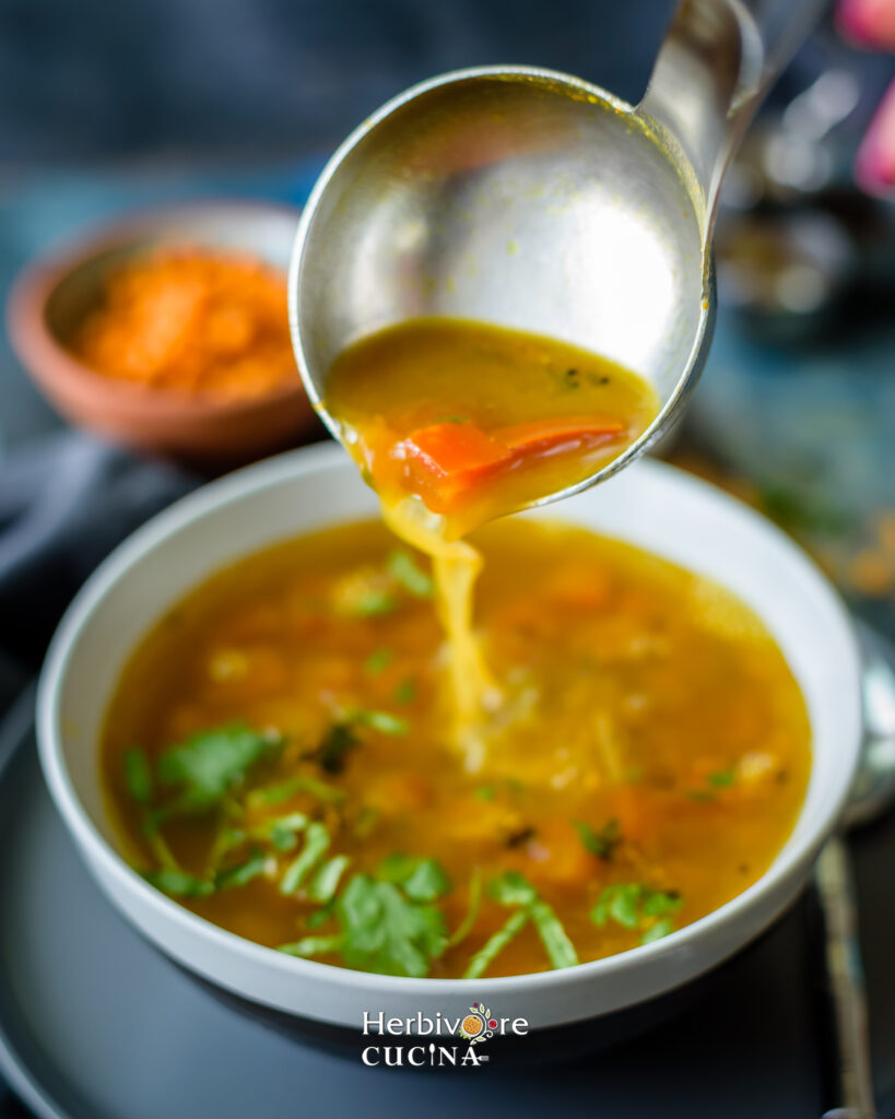 Pouring hot rasam