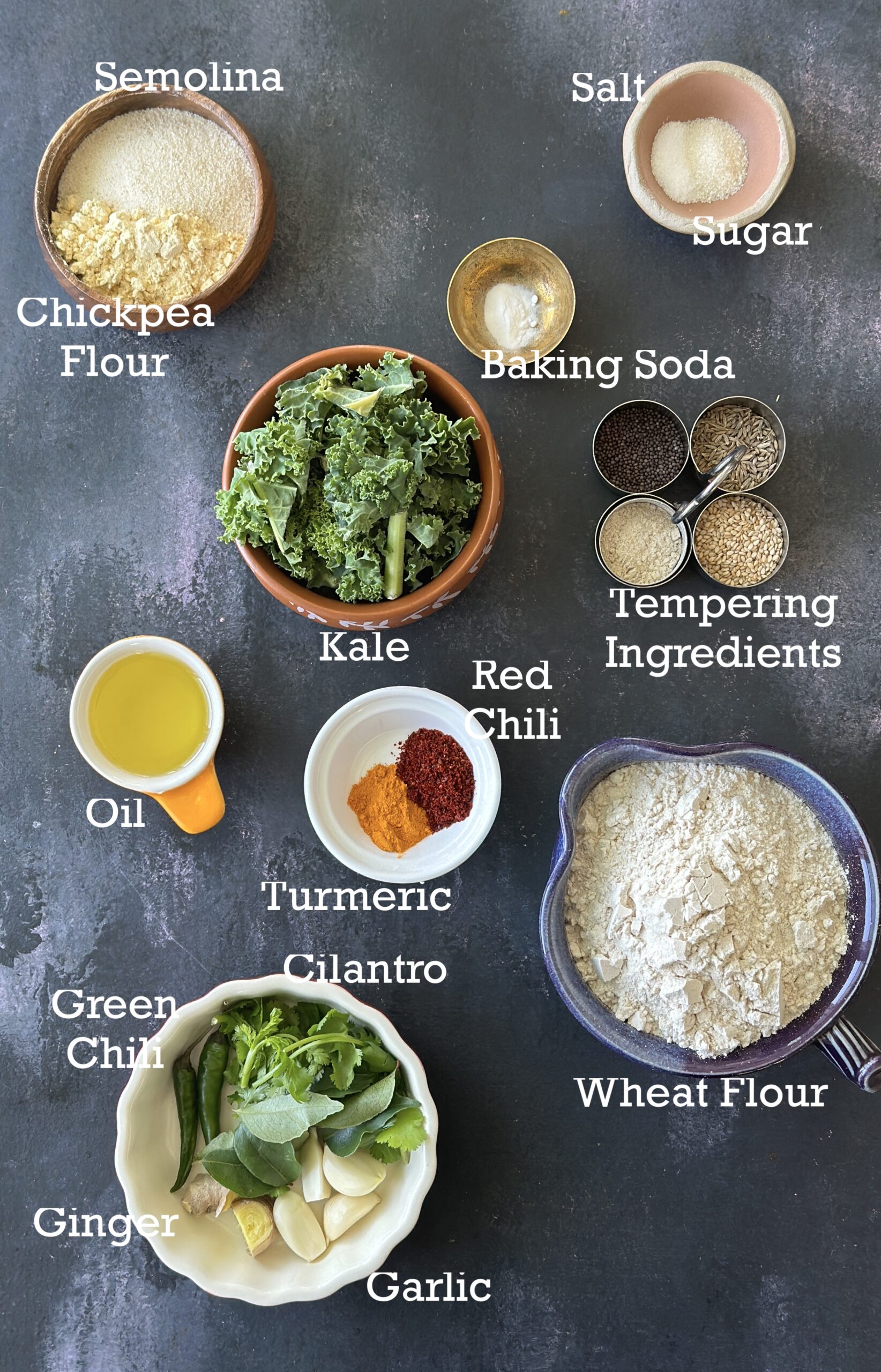 Ingredients for Kale Muthiya; kale, flours, spices and tempering ingredients.