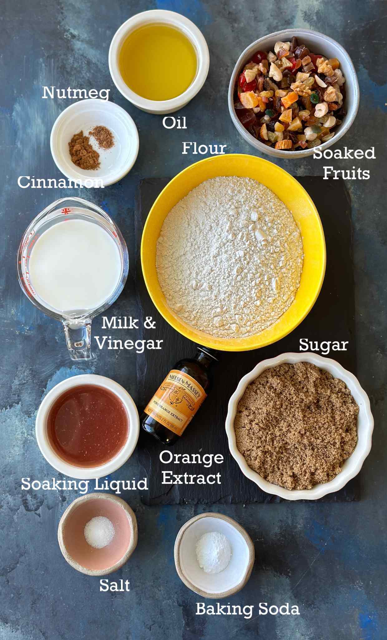 Ingredients to make Christmas Fruit Cake without alcohol in small bowls. 